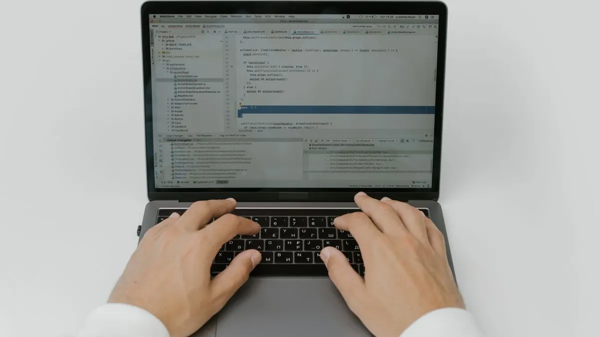 Hands typing on a laptop keyboard