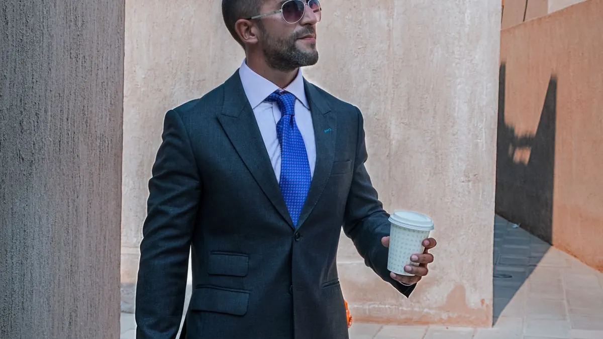Confident businessman in a suit walking outdoors