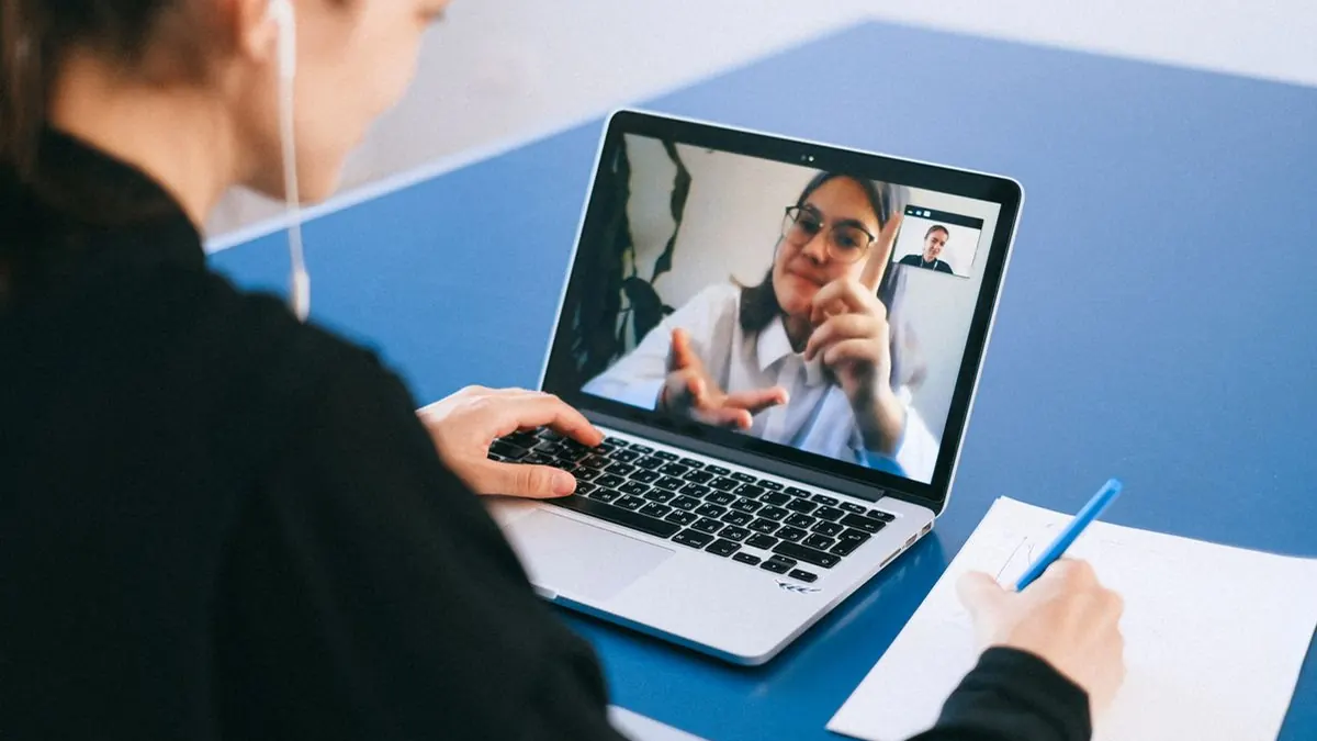 Woman on a video call with a colleague on her laptop